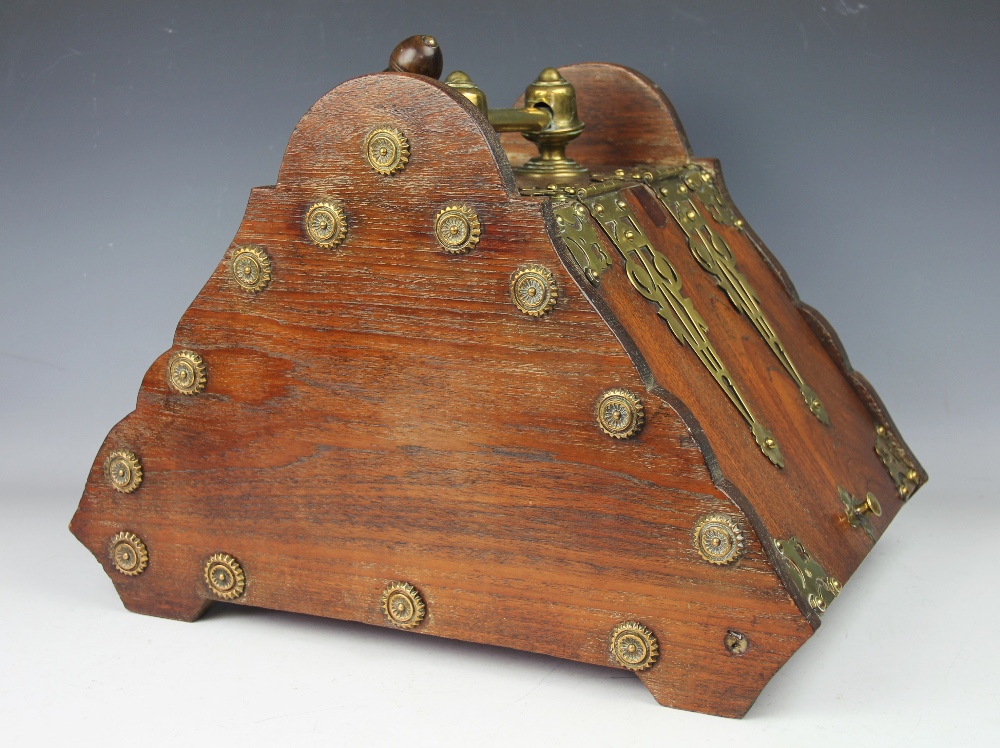A 19th century oak and brass mounted coal purdonium, the canted cover revealing a coal liner,