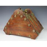 A 19th century oak and brass mounted coal purdonium, the canted cover revealing a coal liner,