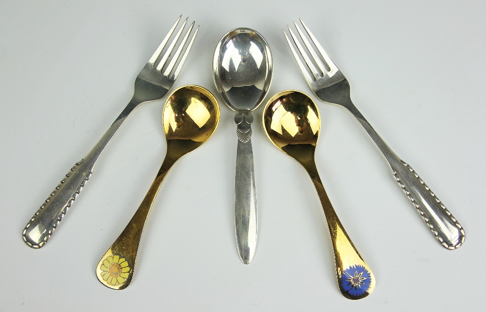 Five Georg Jenson sterling cutlery implements, comprising two gilt calendar spoons, 1973 and 1973,