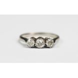A three stone diamond ring, the three old brilliant cut, graduated diamonds,