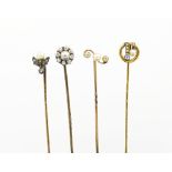 Four pearl and diamond set stick pins, to include; a circular cluster set example,