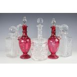 A pair of Victorian cranberry glass ewers and stoppers, 31cm,