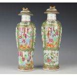 A pair of 19th century Chinese Canton famille rose enamelled high shouldered vases and covers,