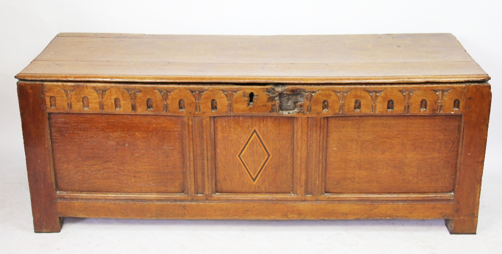 An early 18th century oak coffer, on stile feet,