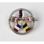 A circular enamelled 'Entent Cordiale' brooch, early 20th century, depicting the Russian, Japanese,