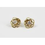 A pair of diamond set stud earrings,