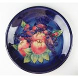 A Moorcroft Finches and Berries plate, 1990, painted 'WM' to underside,