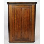 An oak hanging corner cabinet,