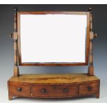 A Regency mahogany bow front toilet mirror, with three drawers, on bracket feet,