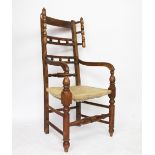 A 19th century beech and ash country kitchen wing back chair, with rush seat, on turned legs,