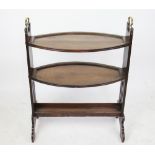 An Arts and Crafts oak three tier dumb waiter, with brass loop handles, on standard end supports,