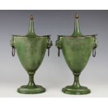 A pair of Regency style green chestnut warmers and covers, of urn form with acorn finials,
