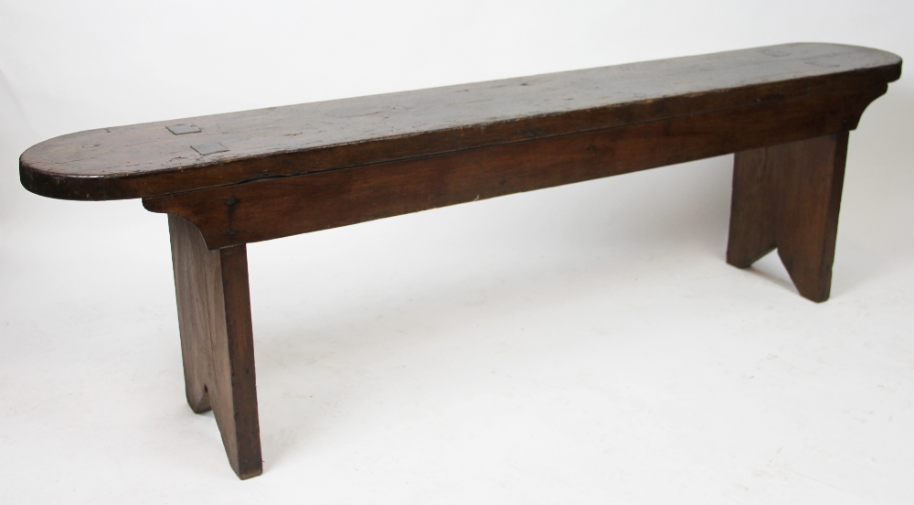 A late 19th century stained pine bench, with rounded ends,