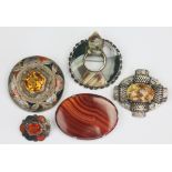 A collection of five Scottish agate set brooches, to include; a garter type example,