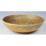 A Ruskin bowl dated 1927, the shallow circular bowl crystalline glazed in tones of orange and blue,