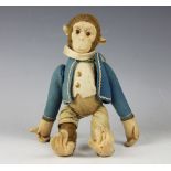 A pre-war wind up 'tumbling monkey' in the manner of Schuco, with glass eyes and blue felt jacket,