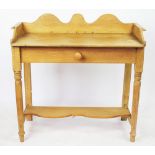 A late Victorian pine wash stand, with serpentine back and drawer, on turned legs,