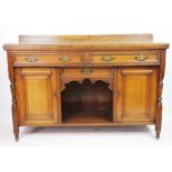 A late golden Victorian oak dresser, with three drawers and two cupboard doors on turned feet,