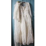 A ladies wedding dress circa 1948, the lace dress with lace bodice and long sleeves,