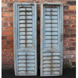 A pair of 19th century French grey painted rustic slatted window shutters, with cast iron furniture,