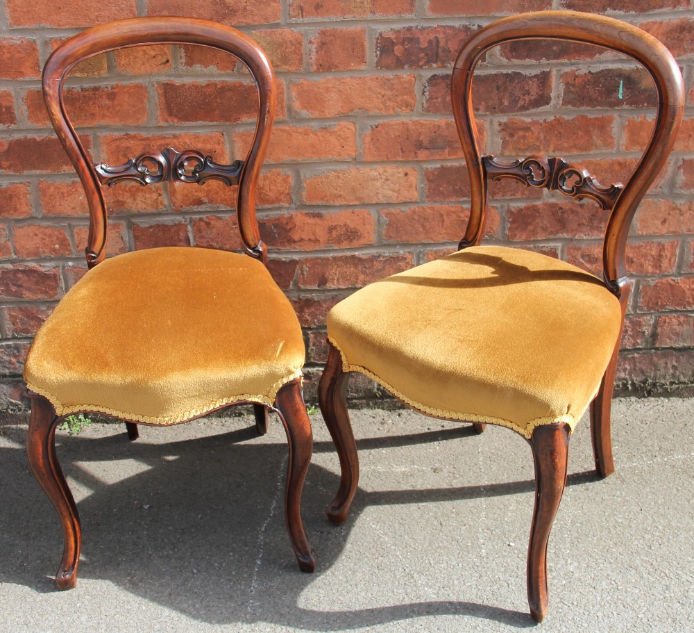 A set of six Victorian walnut dining chairs, with golden dralon upholstered seats,