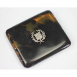 A tortoiseshell pique worked cigarette case, inset with a central coat of arms, 8cm H x 9.