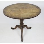 A George III oak circular occasional table, with tilt top,