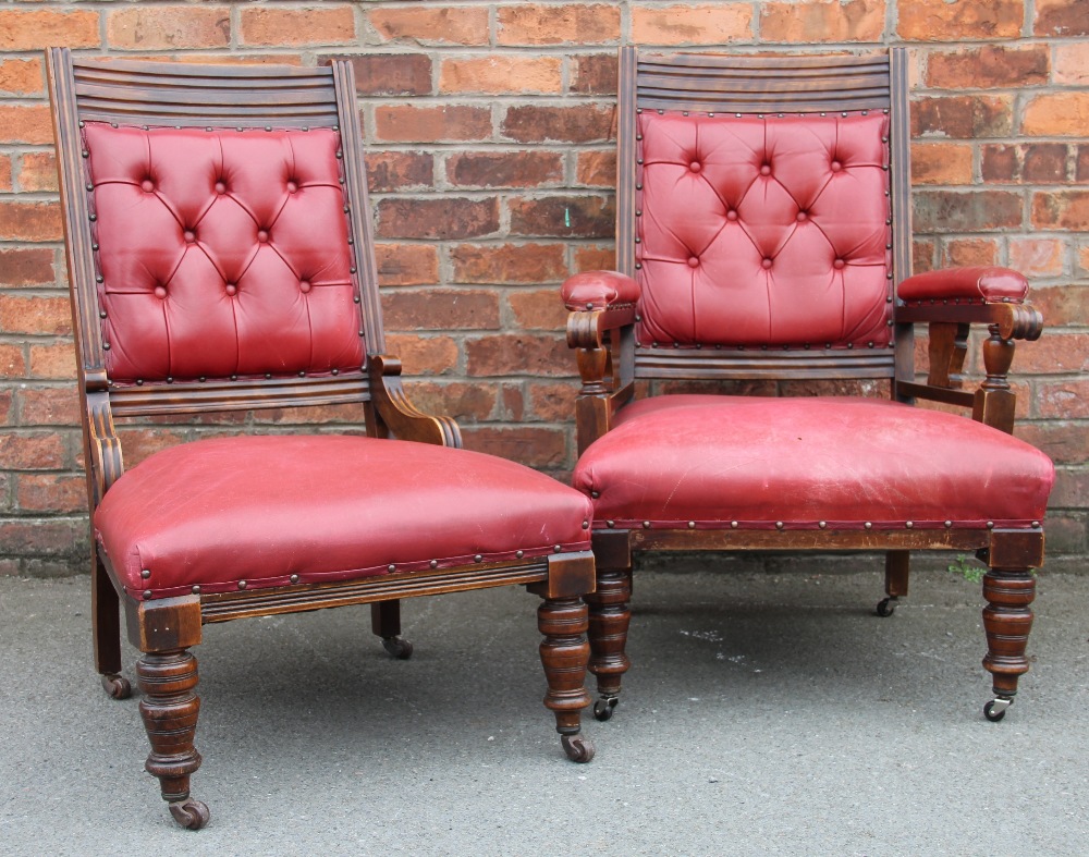 A pair of late Victorian walnut and red leather library chairs, with button backs,