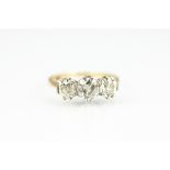 A three stone diamond ring, the three graduated old,