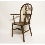 A 20th century ash and elm wheel back Windsor chair, on four turned legs,