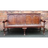 A George III oak settle, with four panel back, on cabriole legs and pad feet, 104cm H x 190cm W,