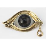 An unusual diamond set 'eye' brooch, London 1990, sponsors mark 'SG',