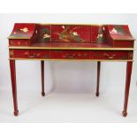 A modern red and floral painted Carlton House style desk, with six small drawers,