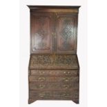 A George III and later carved oak bureau bookcase,