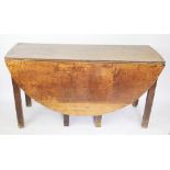 An 18th century provincial oak gate leg table, with circular top, on chamfered square legs,