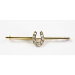 A diamond set horseshoe bar brooch, set with nine graduated rose and old cut diamonds,