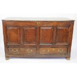 An 18th century oak mule chest, with hinged top and quadruple panelled front over two drawers,