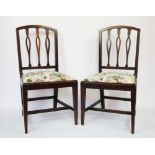 A pair of late George III mahogany dining chairs, with pierced bar backs and drop in seats,