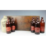 A vintage stained pine Ansells Home Service bottle rack, early 20th century,