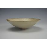 A Chinese Song style Ding/Ting ware bowl, of conical form with an allover cream glaze,
