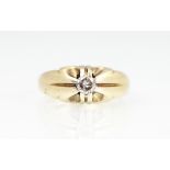 A diamond set ring, the central brilliant cut diamond within gypsy claw setting,