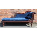 A Victorian mahogany chaise lounge, with scroll back and blue upholstery, on turned and carved legs,
