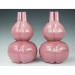 A pair of Chinese pink glazed three section gourded vases,