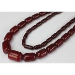 A 'cherry' amber Art Deco bead necklace, designed as fifty one beads,