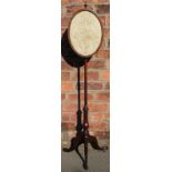 A George III mahogany pole screen, the oval panel inset with an embroidered,