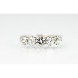 A five stone diamond ring, the five graduated old brilliant cut diamonds,