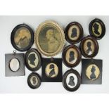 A collection of 18th century and later family silhouettes and oval pencil portraits to include