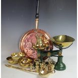 A set of green kitchen scales and brass weights,