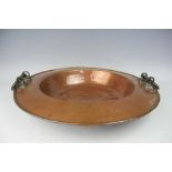 A 19th century large copper dish, with bronze loop handles,