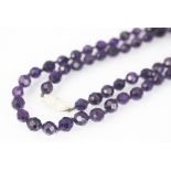 An amethyst bead necklace,